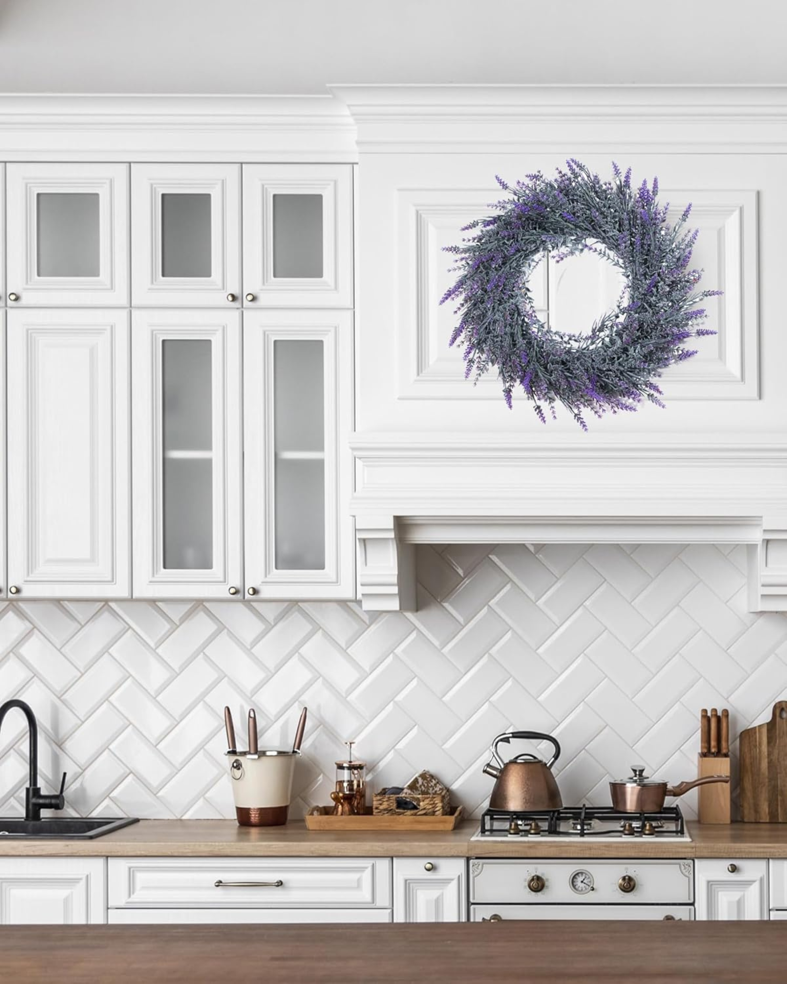 A 18 inch year round artificial lavender wreath is hanging on the kitchen cabinet.