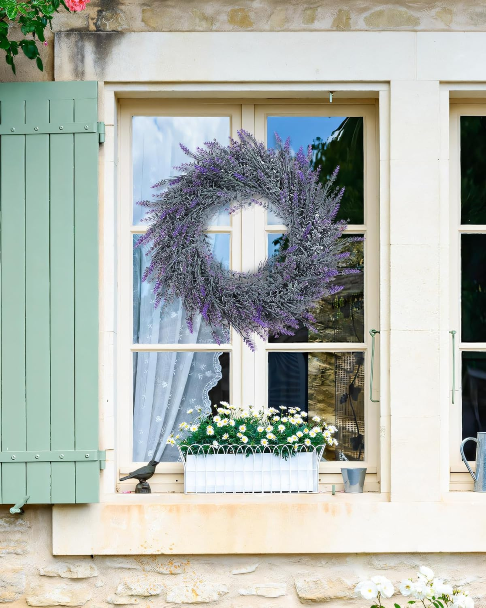 A 18 inch year round artificial lavender wreath is hanging on the window.