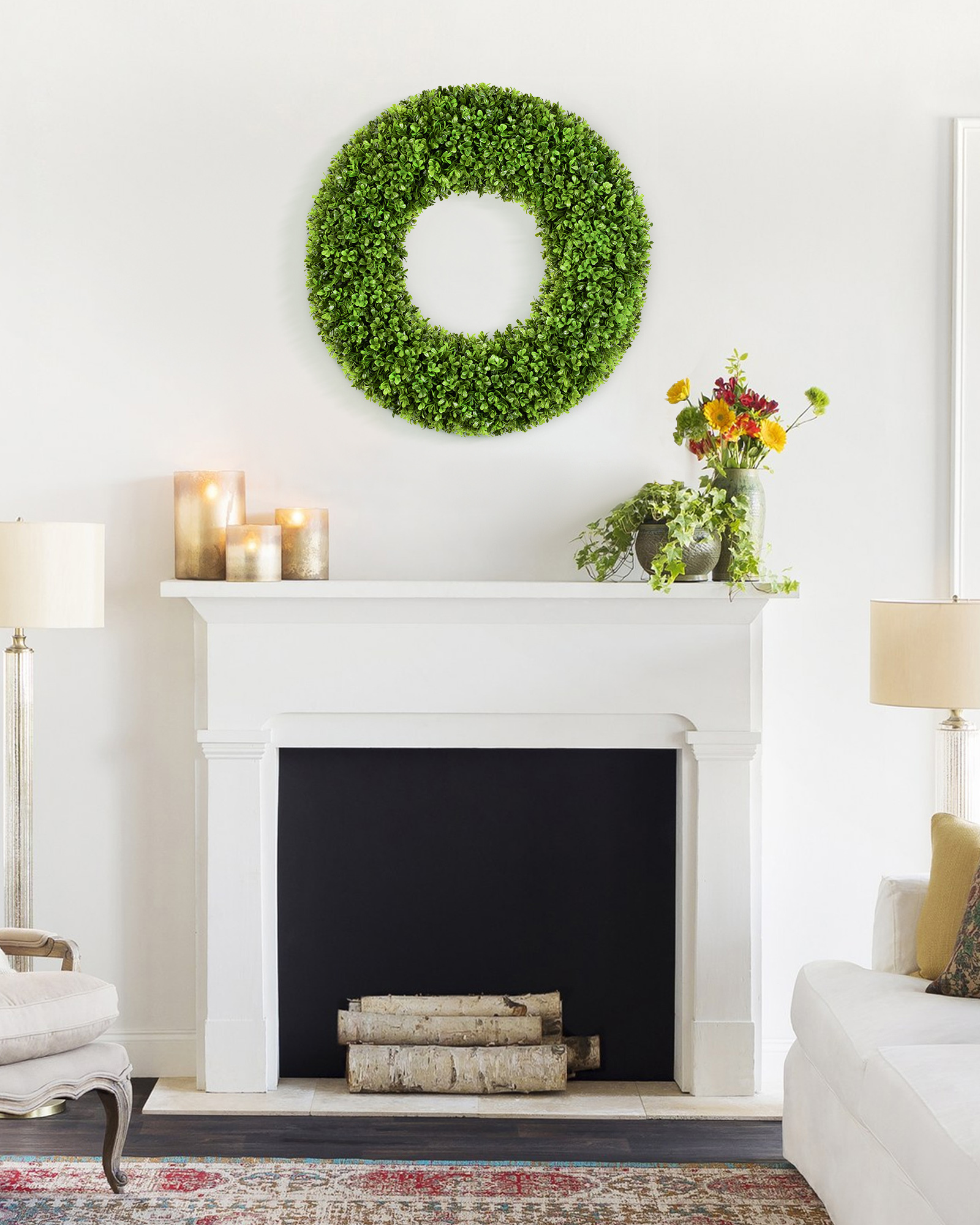 20 inch year round artificial boxwood wreath is hanging over fireplace.
