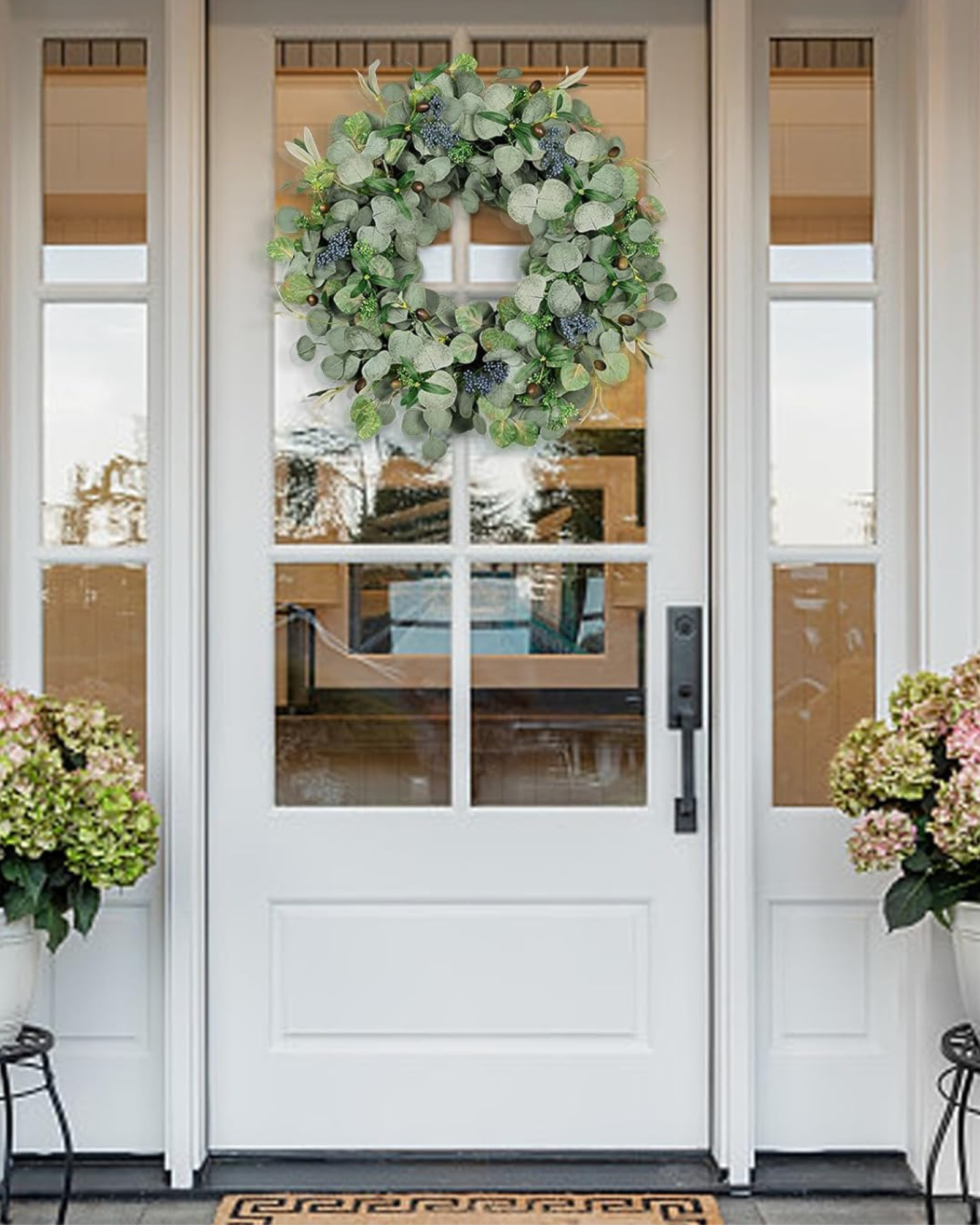A 24 inch year round eucalyptus wreath is hanging on the front door.