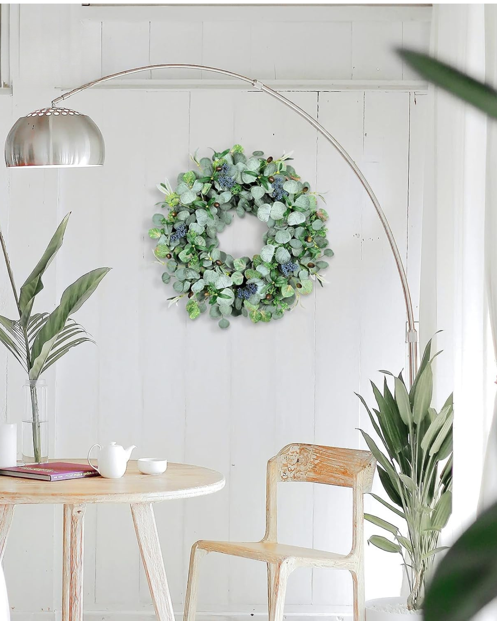 A 24 inch year round eucalyptus wreath is hanging on the living room.