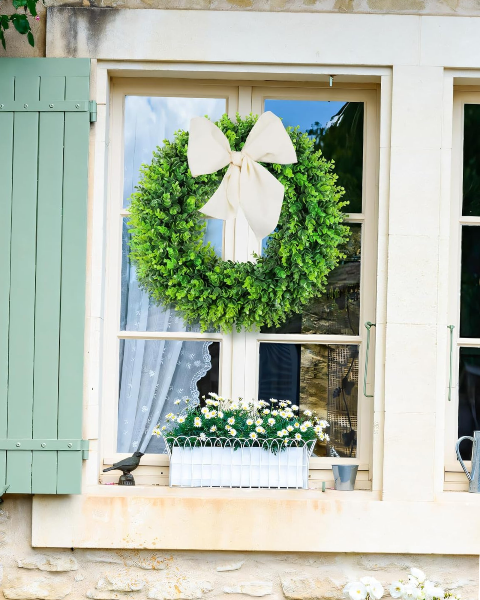 A 20 inch year round greenery boxwood wreath on window.
