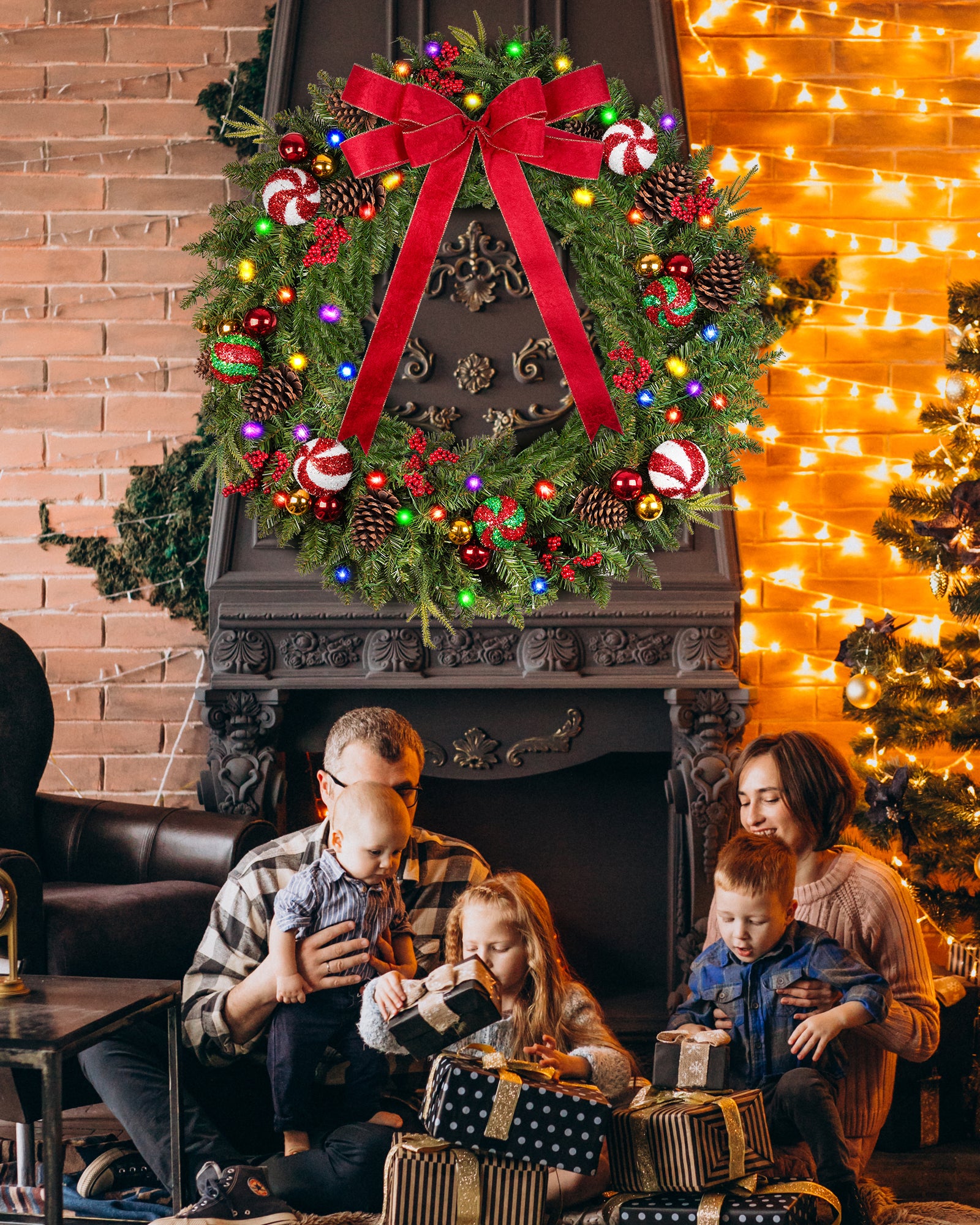 A happy family is sitting in the living room and the christmas wreath is hanging over the fireplace.