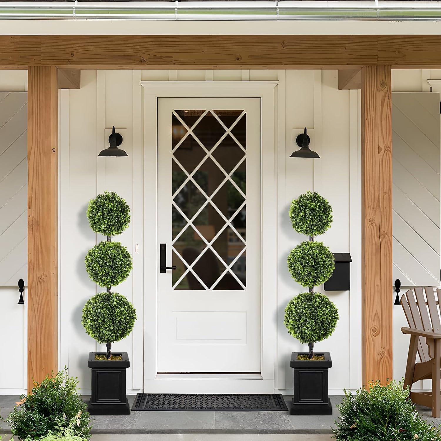 4ft artificial boxwood topiary trees set of 2 is standing in the front porch.
